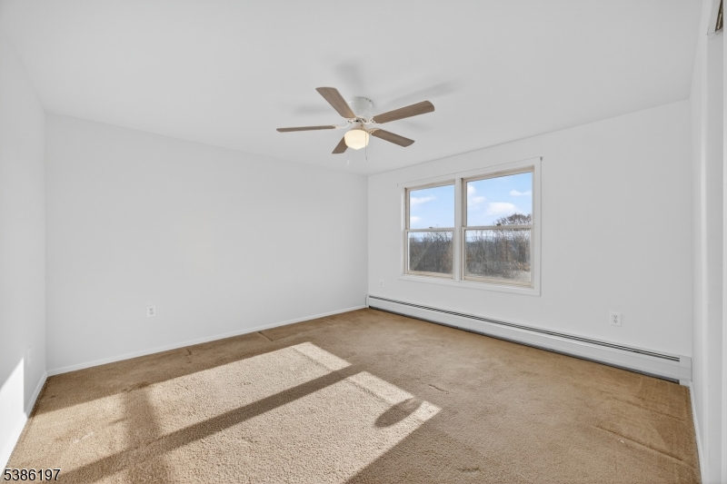 61 Coykendall Road Wantage, NJ 07461 - Photo 21 of 43 an empty room with a window and a ceiling fan