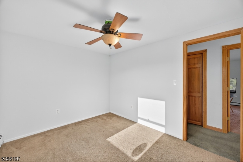 61 Coykendall Road Wantage, NJ 07461 - Photo 24 of 43 an empty room with closet and a chandelier fan