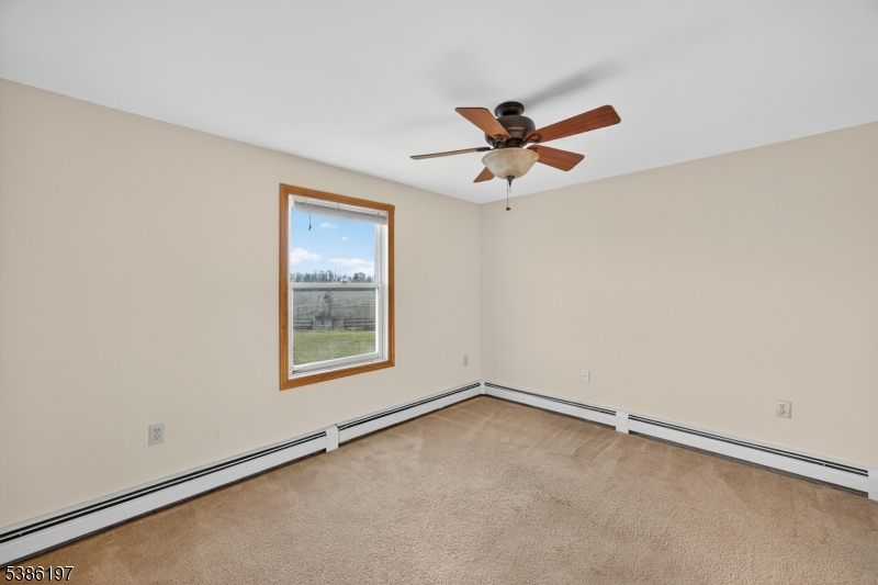 61 Coykendall Road Wantage, NJ 07461 - Photo 26 of 43 an empty room with a window and a fan