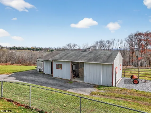 a view of a house with a backyard and a lake view