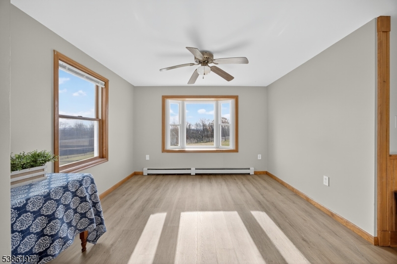 61 Coykendall Road Wantage, NJ 07461 - Photo 9 of 43 wooden floor in an empty room with a window