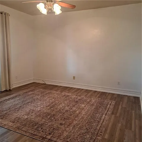 a view of a hallway with wooden floor and stairs