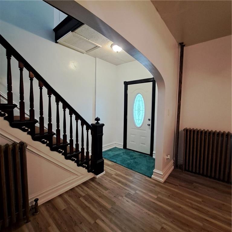 439 Longfellow Street Vandergrift, PA 15690 - Photo 14 of 49 a view of a hallway with wooden floor and stairs