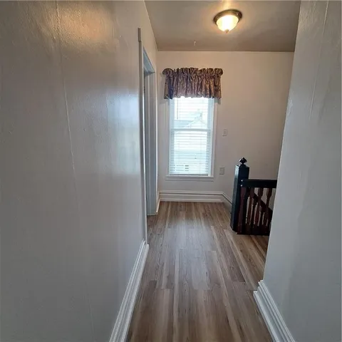 en empty room with windows and fan