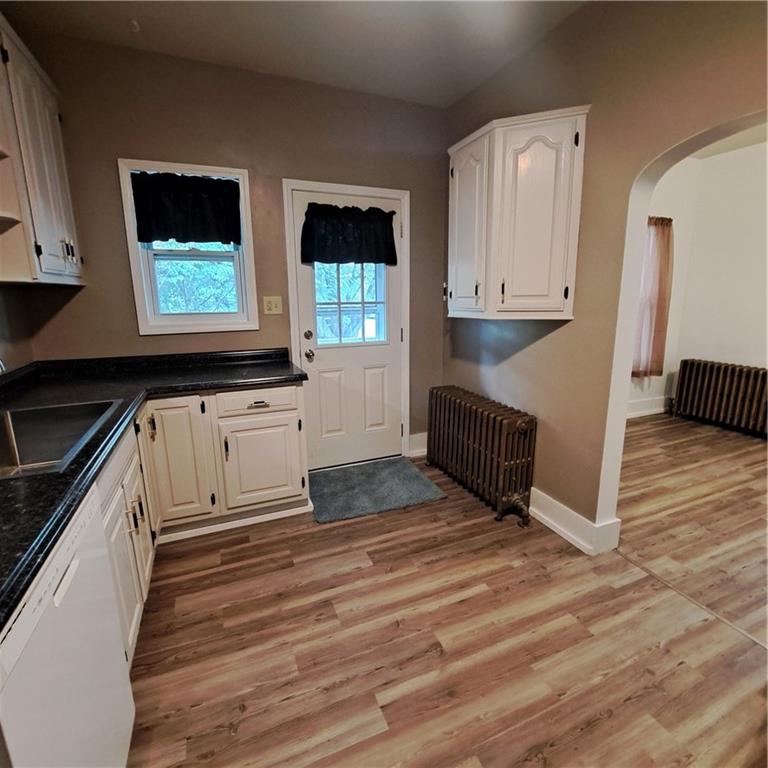 439 Longfellow Street Vandergrift, PA 15690 - Photo 6 of 49 a kitchen with granite countertop a stove a sink and a microwave