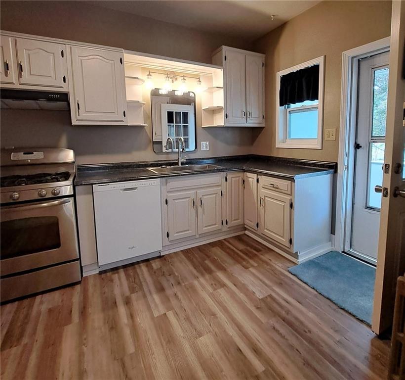 439 Longfellow Street Vandergrift, PA 15690 - Photo 7 of 49 a kitchen with granite countertop wooden cabinets stainless steel appliances and a window