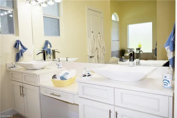 a bathroom with a sink vanity and a mirror