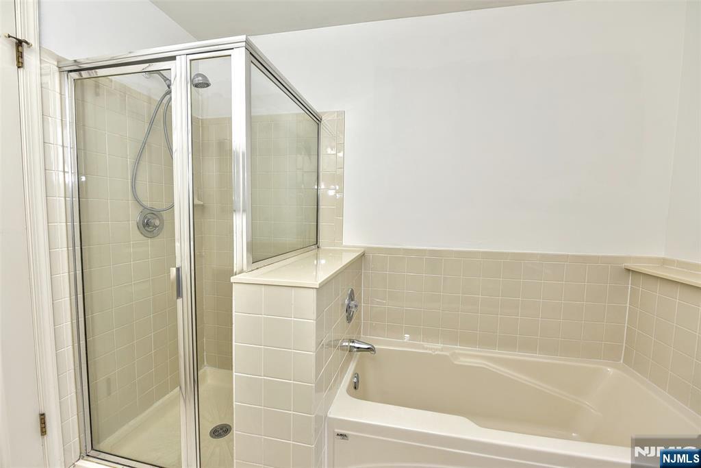 1499 Cornwall Road Mahwah, NJ 07430 - Photo 14 of 26 a bathroom with a bathtub and a shower