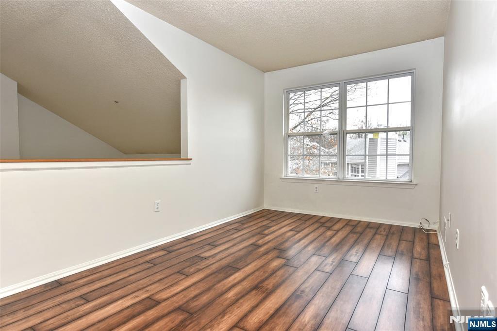 1499 Cornwall Road Mahwah, NJ 07430 - Photo 16 of 26 an empty room with wooden floor and windows