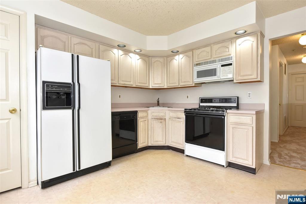1499 Cornwall Road Mahwah, NJ 07430 - Photo 9 of 26 a kitchen with stainless steel appliances a refrigerator sink and cabinets