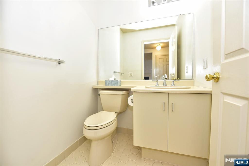 1499 Cornwall Road Mahwah, NJ 07430 - Photo 10 of 26 a bathroom with a granite countertop sink toilet and a mirror