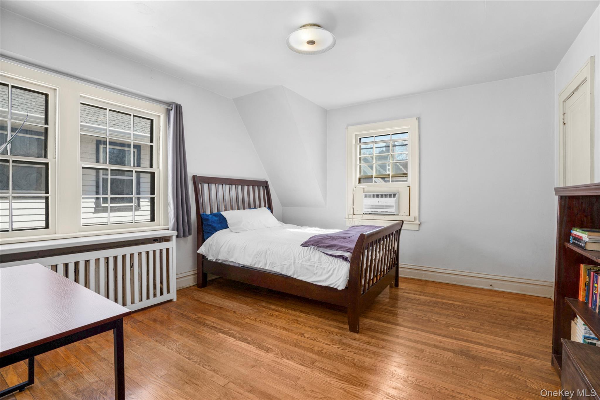 116 Reed Avenue Pelham, NY 10803 - Photo 12 of 22 a bedroom with a bed and wooden floor