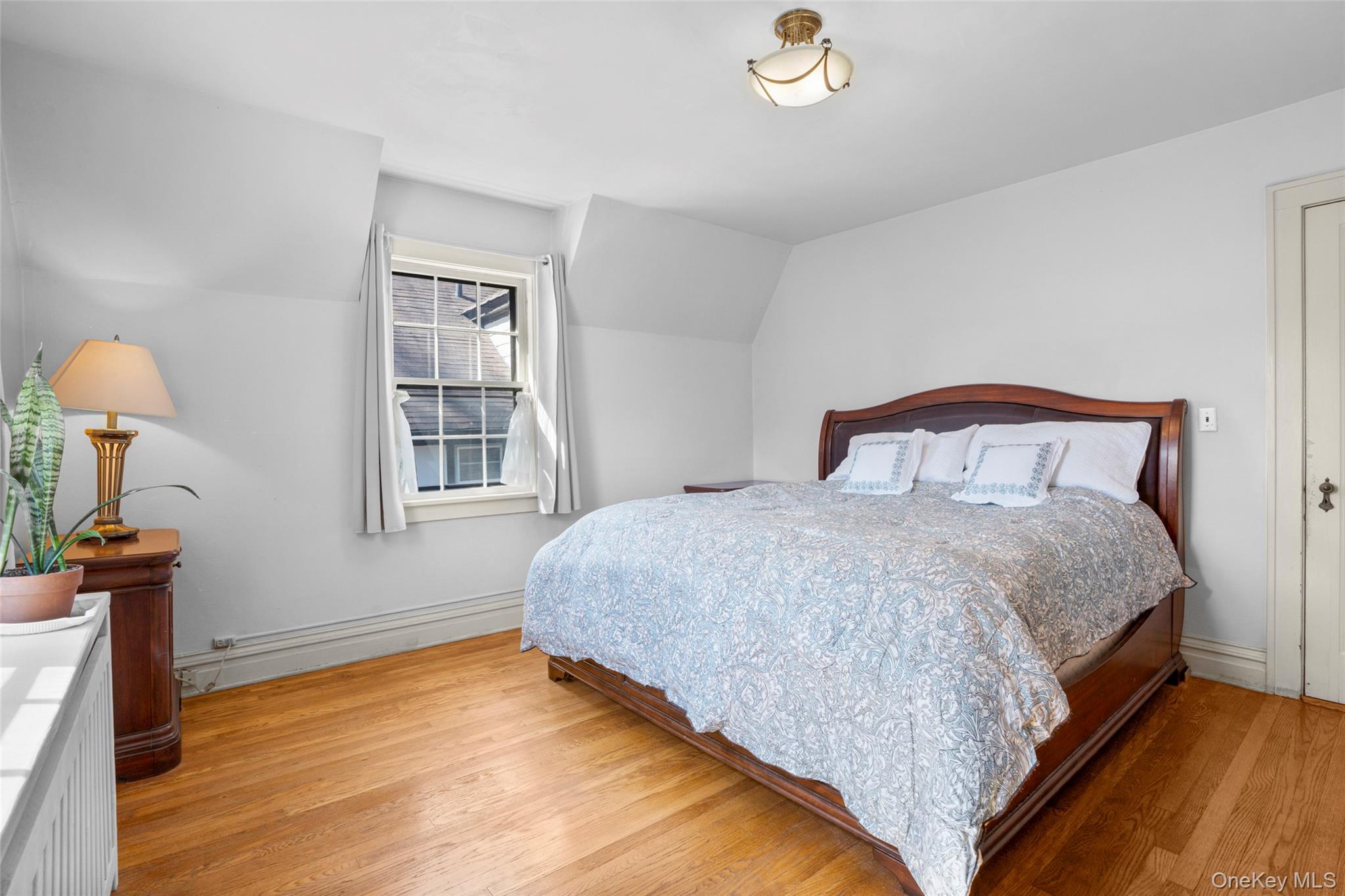 116 Reed Avenue Pelham, NY 10803 - Photo 13 of 22 a bedroom with a bed and a window