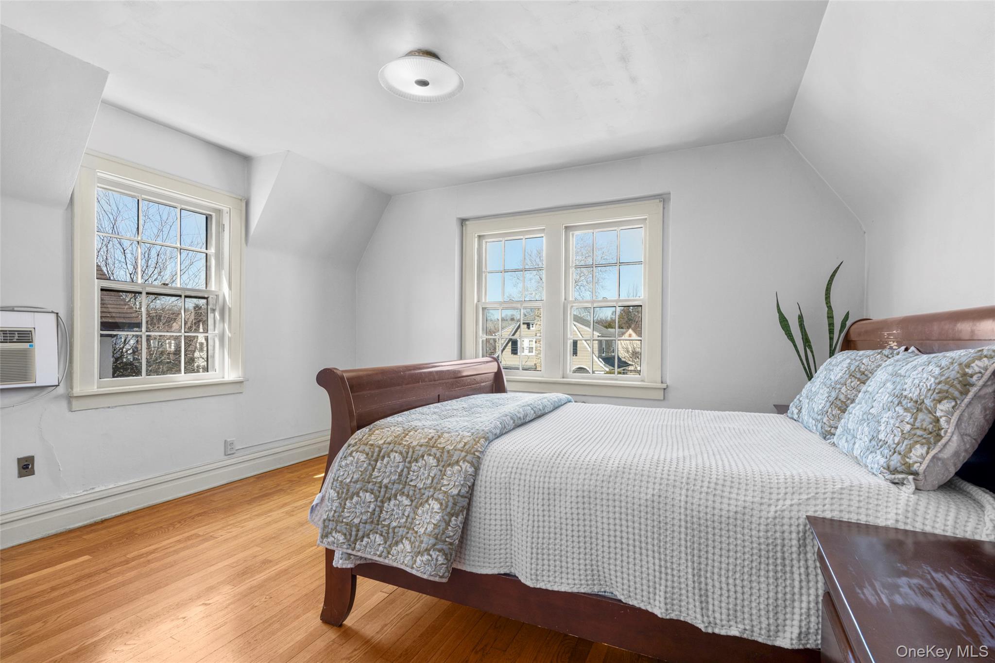 116 Reed Avenue Pelham, NY 10803 - Photo 14 of 22 a bedroom with a large bed and wooden floor