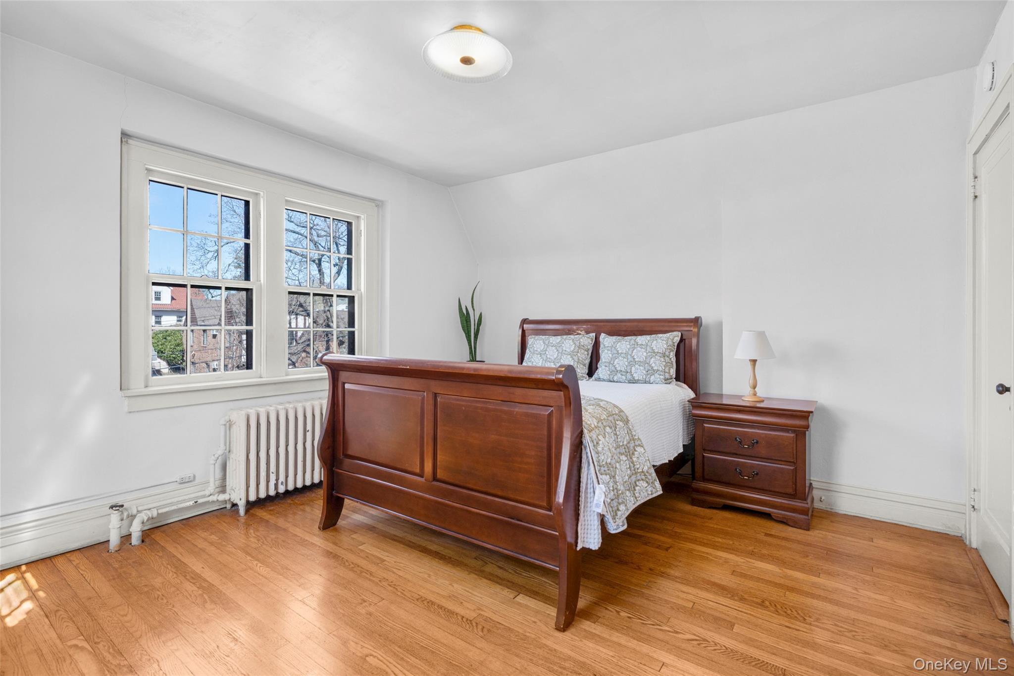 116 Reed Avenue Pelham, NY 10803 - Photo 15 of 22 a bedroom with a bed and a window