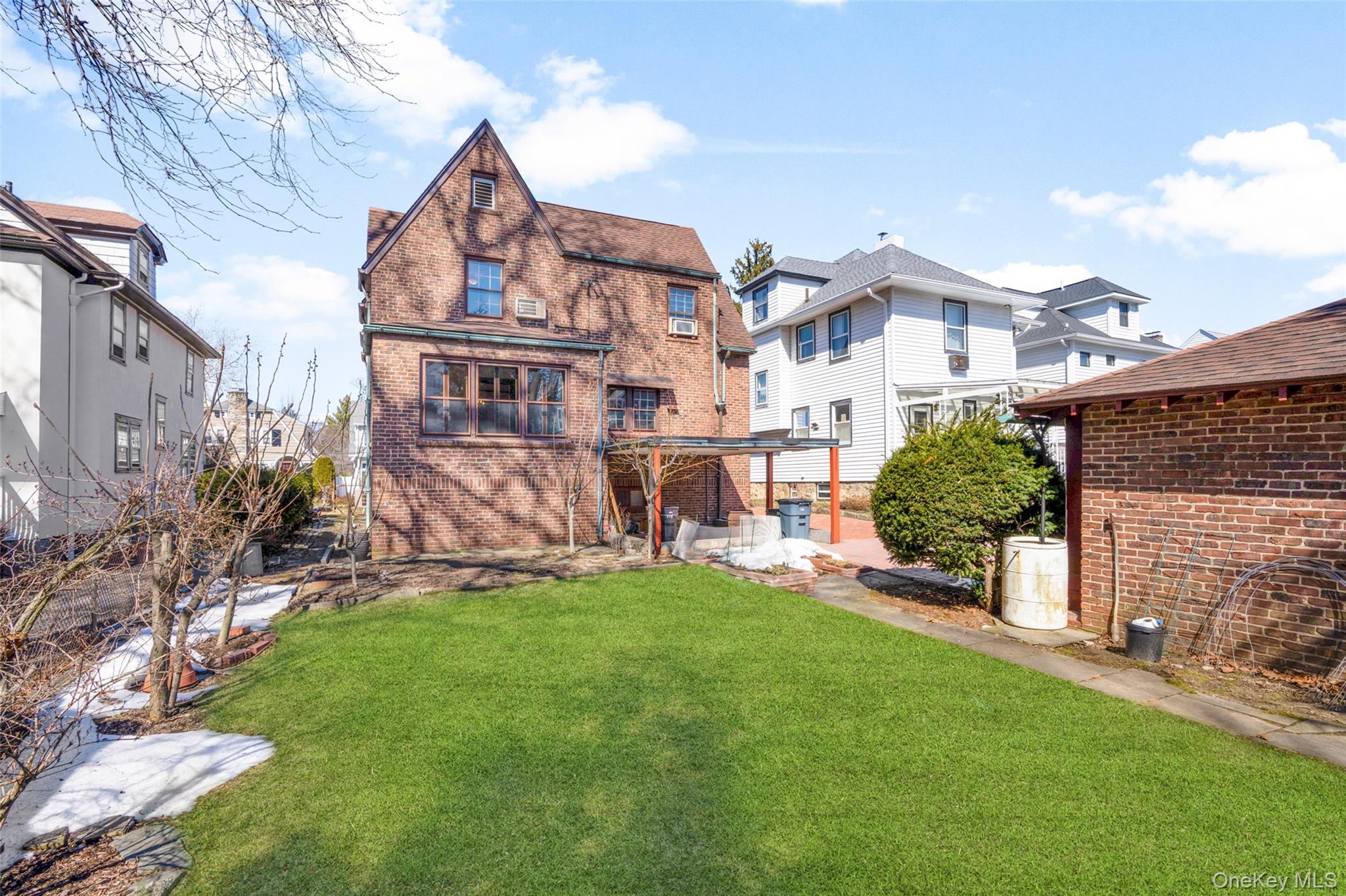 116 Reed Avenue Pelham, NY 10803 - Photo 17 of 22 a view of a house with a yard and a garden