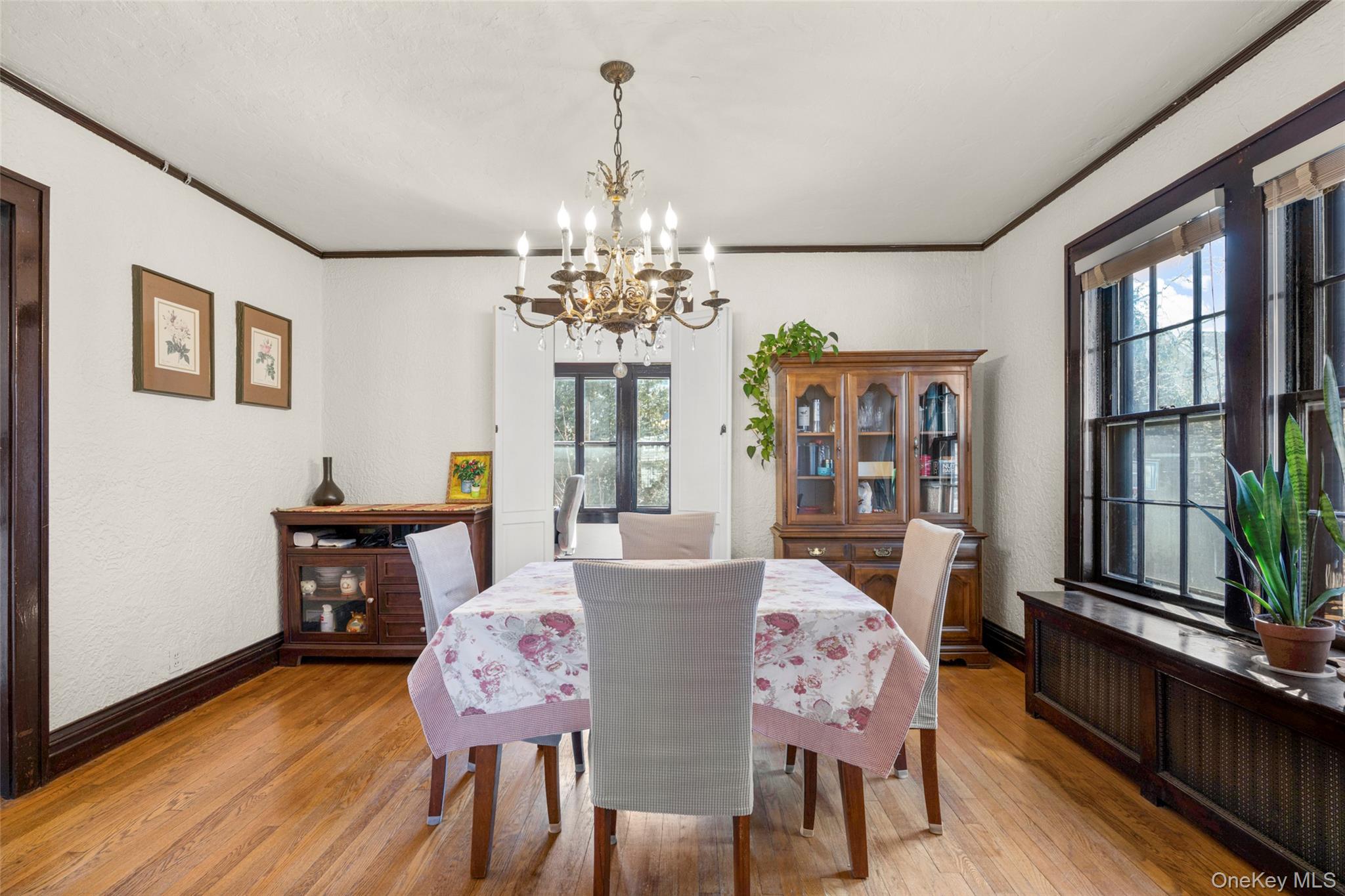 116 Reed Avenue Pelham, NY 10803 - Photo 7 of 22 a view of a dining room with furniture a chandelier and wooden floor