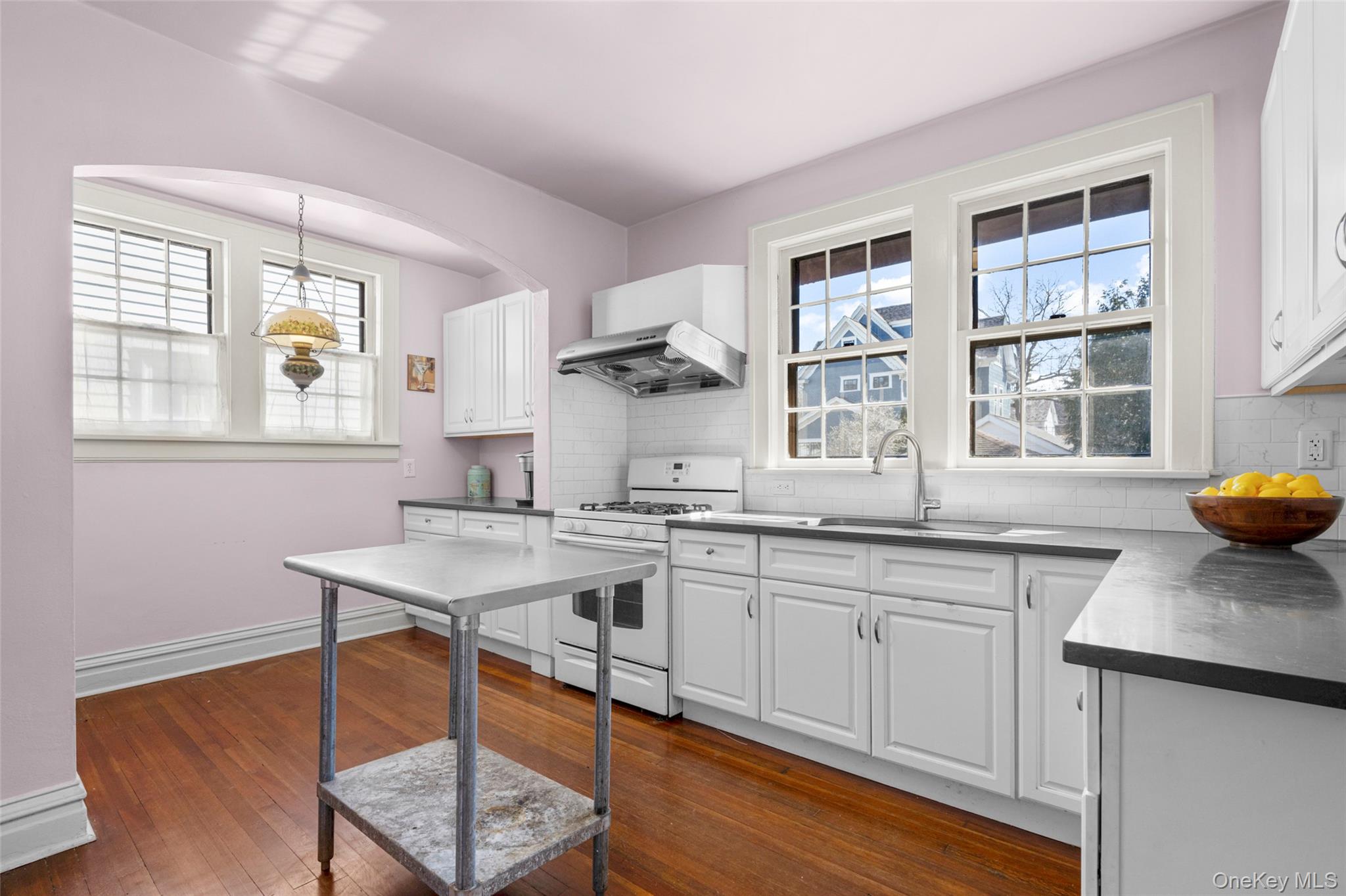 116 Reed Avenue Pelham, NY 10803 - Photo 8 of 22 a kitchen with stainless steel appliances granite countertop a stove a sink and a refrigerator