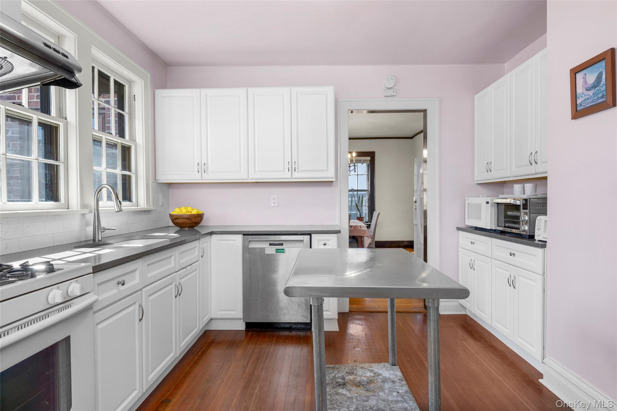 116 Reed Avenue Pelham, NY 10803 - Photo 9 of 22 a kitchen with stainless steel appliances granite countertop a stove a sink dishwasher and cabinets with wooden floor