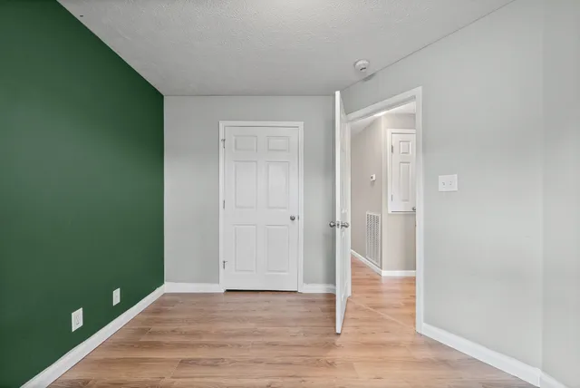 a view of an empty room and wooden floor