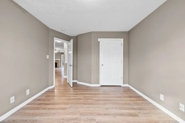 a view of an empty room and wooden floor