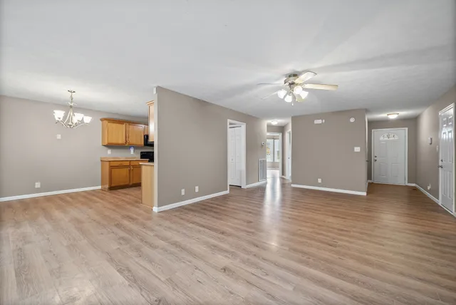 a view of an empty room with a kitchen