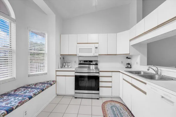 a kitchen with a stove a sink and a microwave