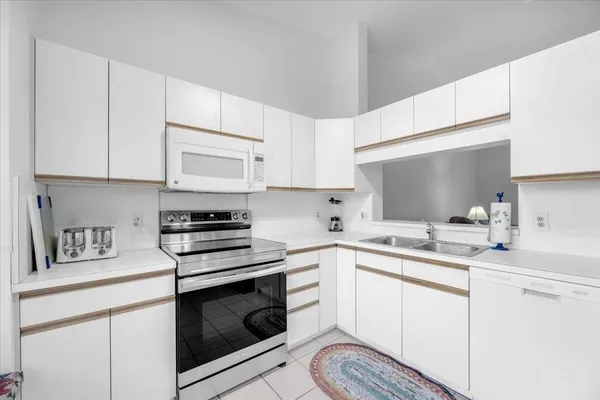 a kitchen with cabinets appliances a sink and a counter top