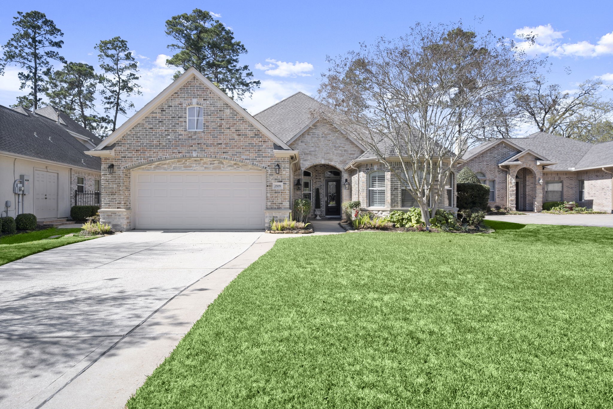 a front view of a house with a yard and trees