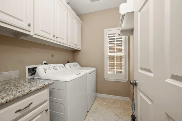 a utility room with closet dryer and washer