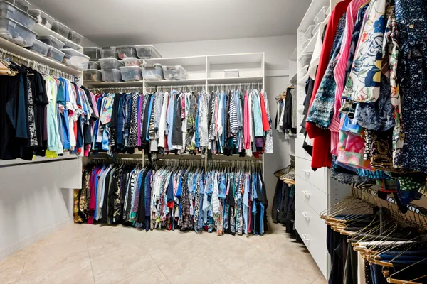 a view of walk in closet with clothes