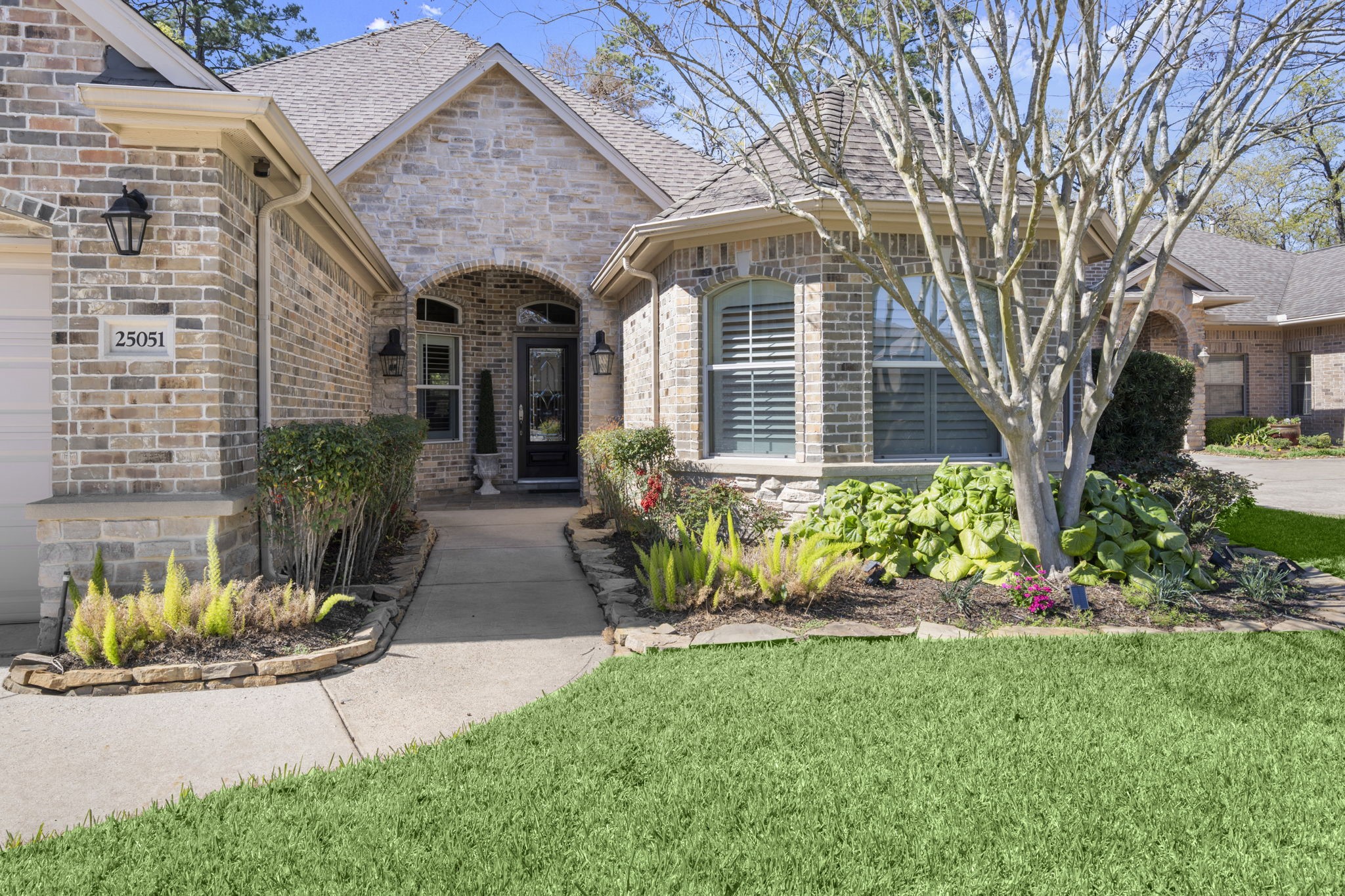 25051 Bow Wood Court Spring, TX 77389 - Photo 2 of 22 a front view of a house with garden and seating area