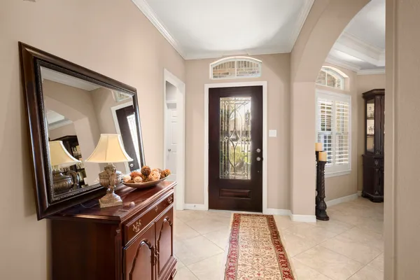 a view of a livingroom with wooden floor and a mirror