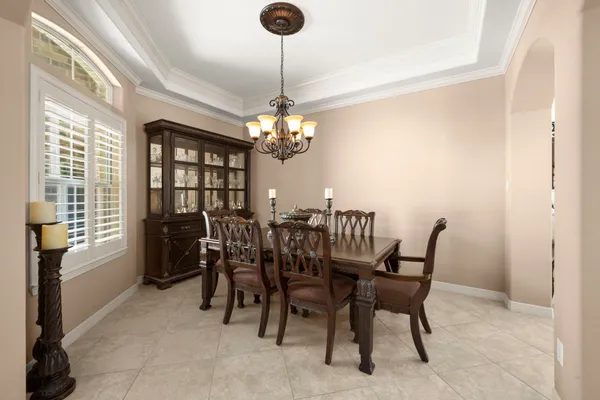 a view of a dining room with furniture and chandelier