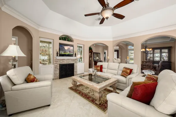 a living room with furniture fireplace and a chandelier