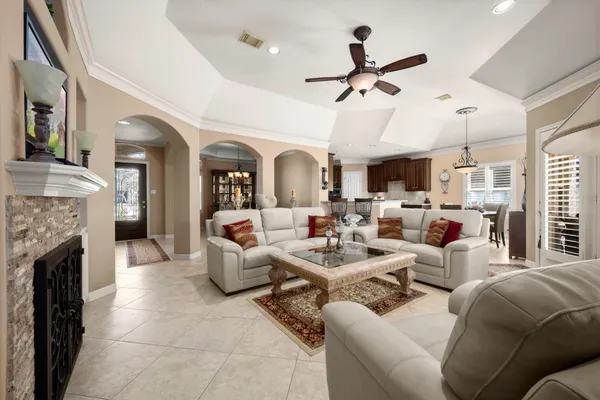 a living room with furniture fireplace and a window