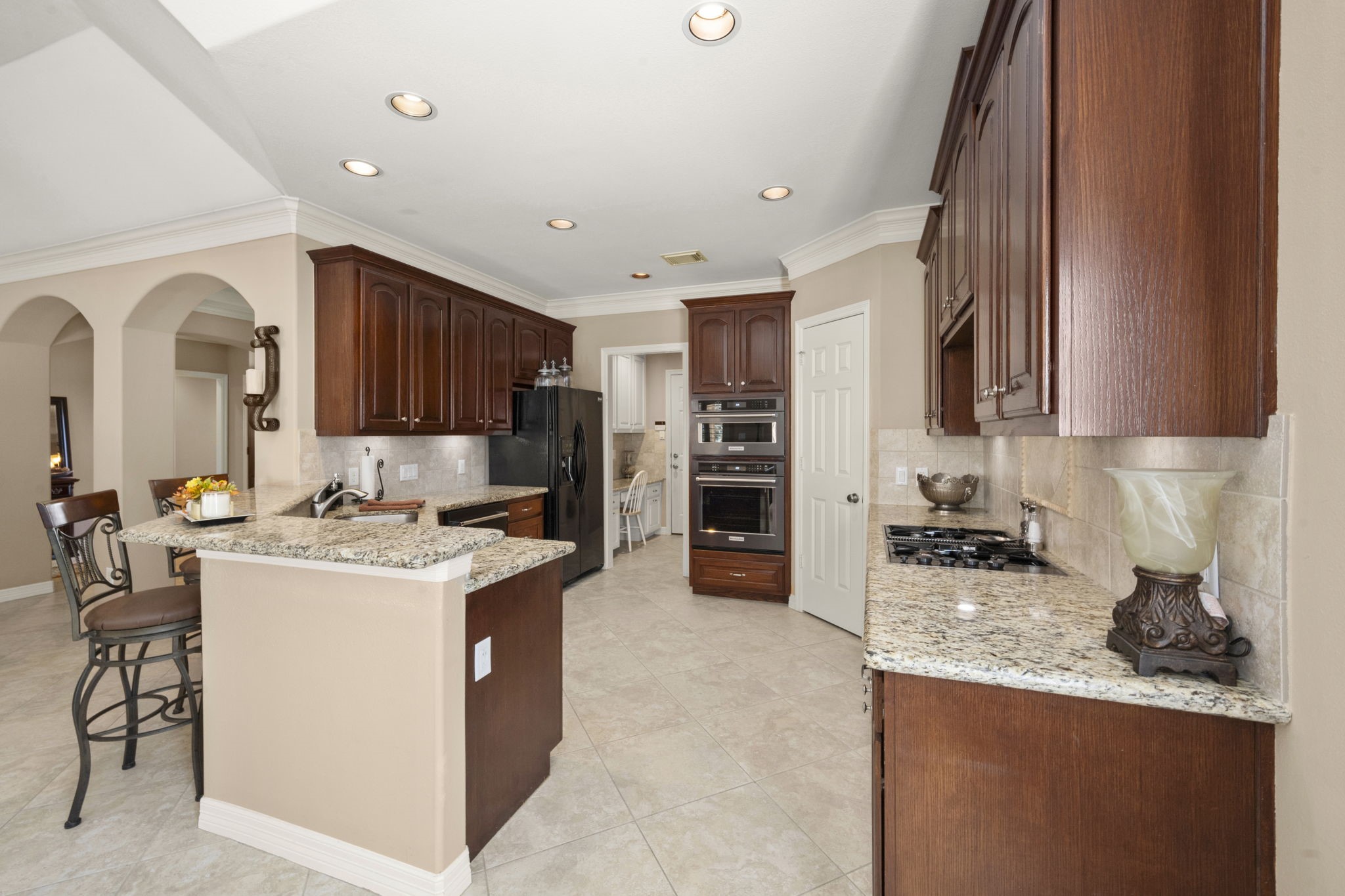 25051 Bow Wood Court Spring, TX 77389 - Photo 7 of 22 a kitchen with a sink a stove and refrigerator