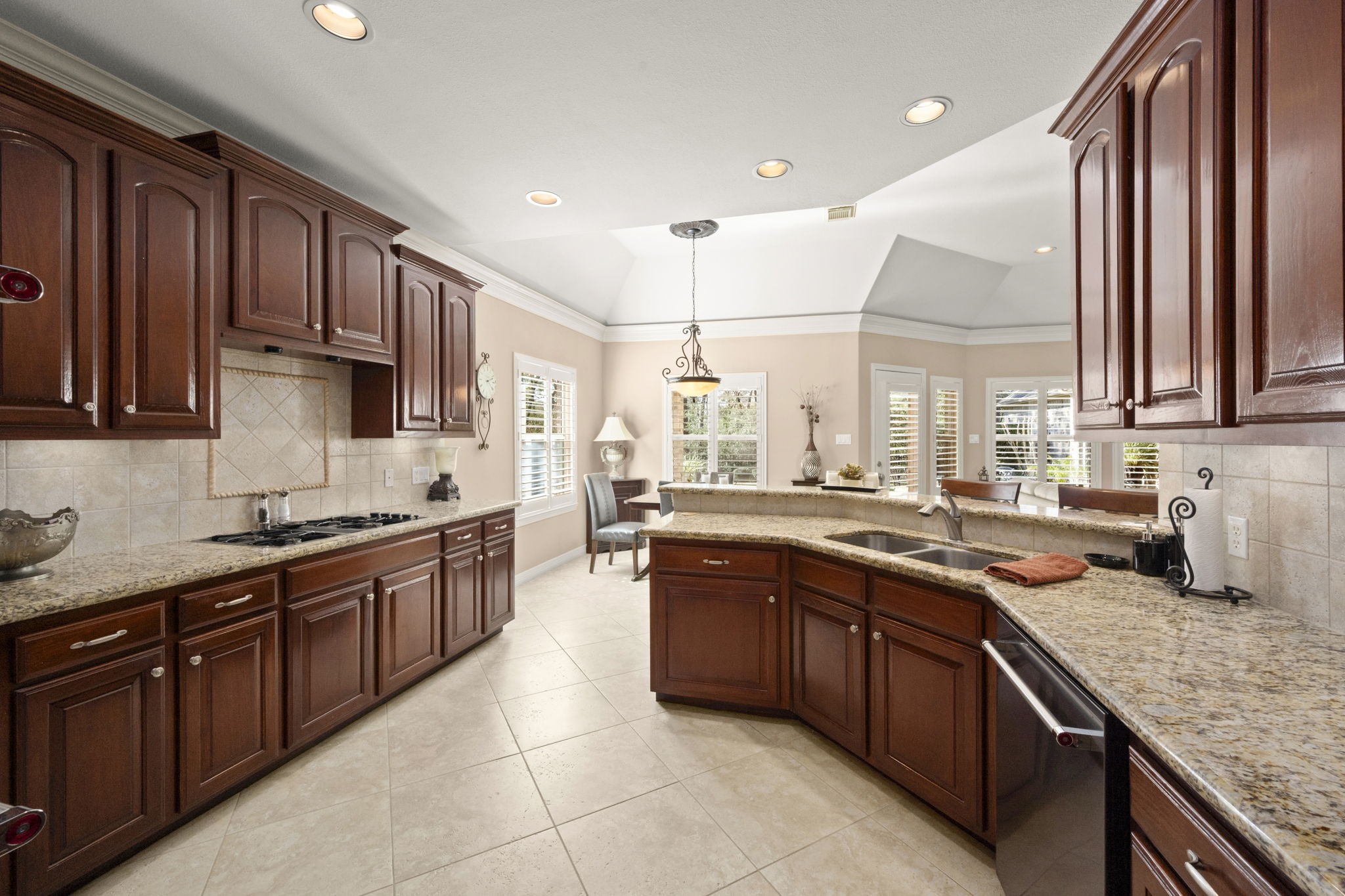 25051 Bow Wood Court Spring, TX 77389 - Photo 8 of 22 a kitchen with stainless steel appliances granite countertop wooden cabinets a sink and dishwasher a stove top oven with wooden floor