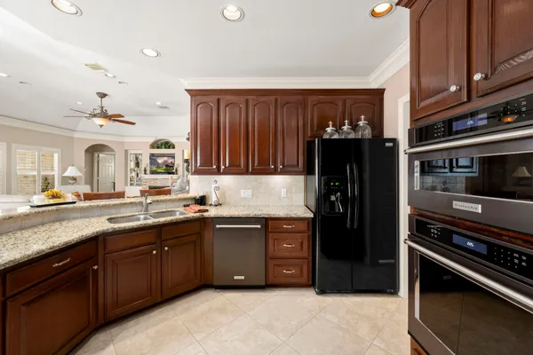 a kitchen with stainless steel appliances granite countertop a refrigerator and a sink