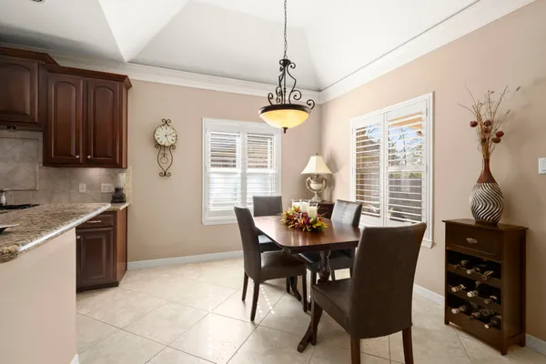 a dining room with furniture a chandelier and window