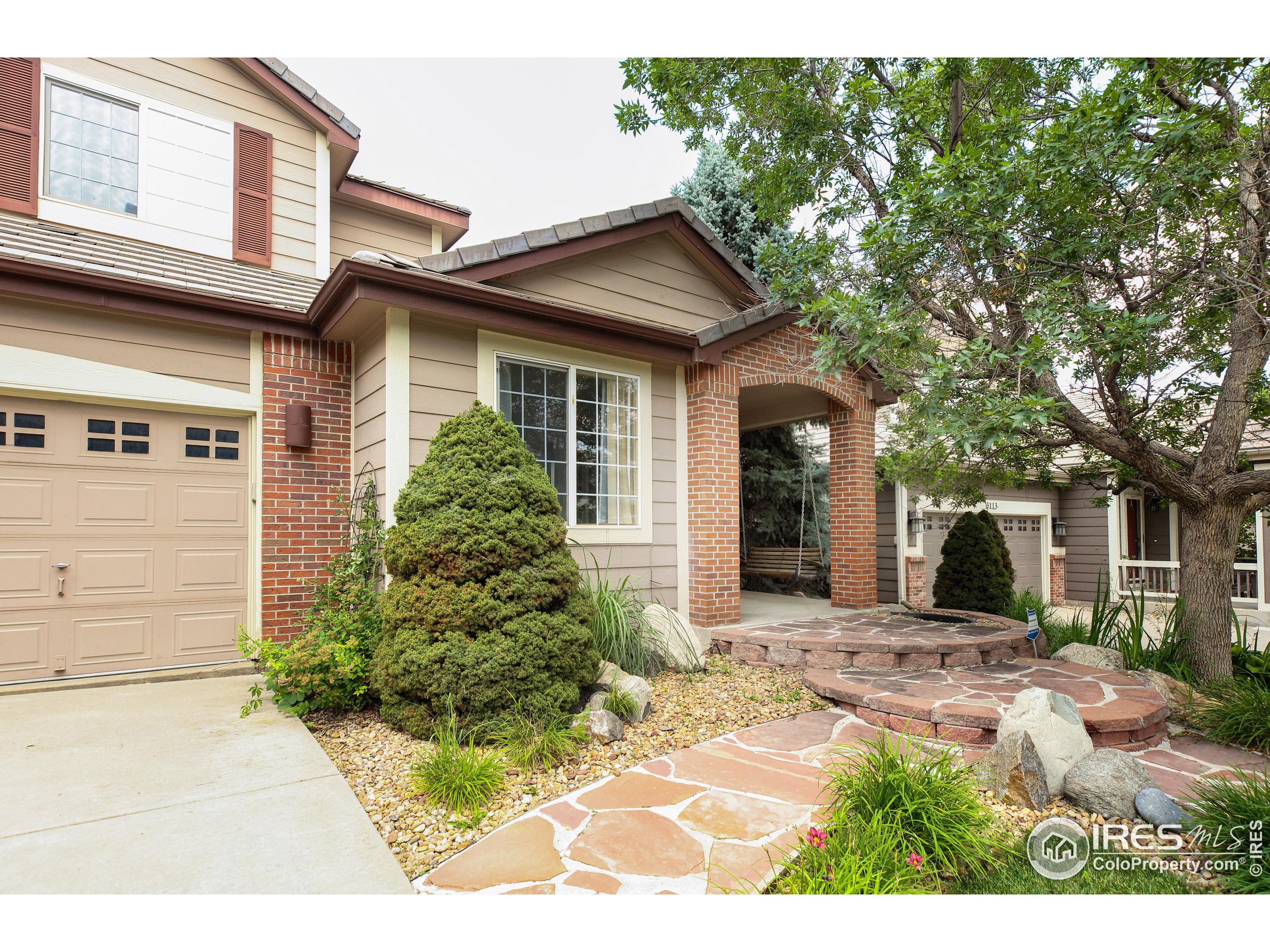 3123 Castle Peak Avenue Superior, CO 80027 - Photo 1 of 40 a front view of a house with garden