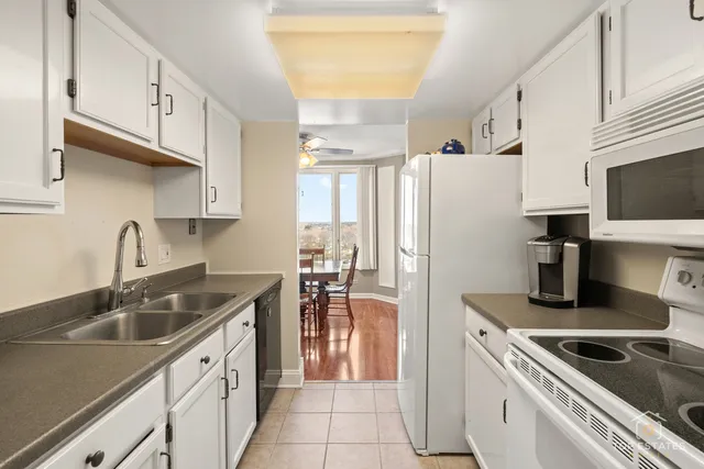 a kitchen that has a sink cabinets counter space and appliances