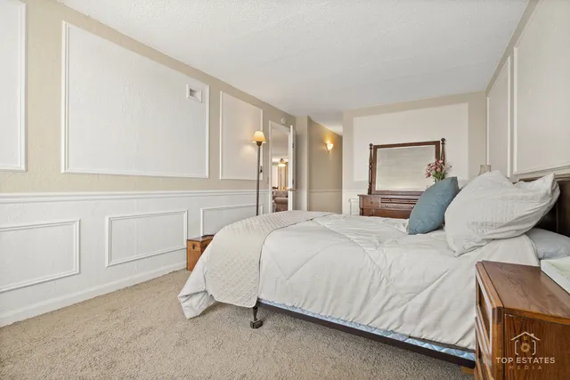 a bedroom with a bed and chair