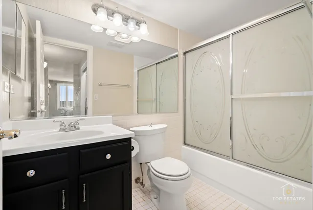 a bathroom with a double vanity sink mirror and toilet
