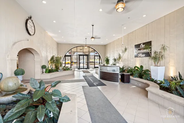 a living room with furniture potted plant and a chandelier