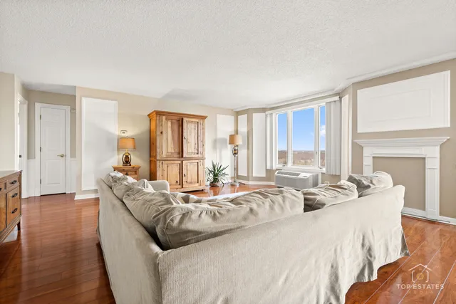 a large bedroom with bed and large windows