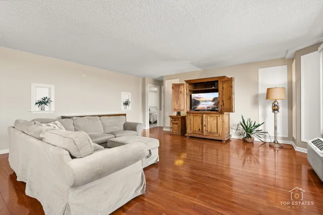 a living room with furniture and a wooden floor