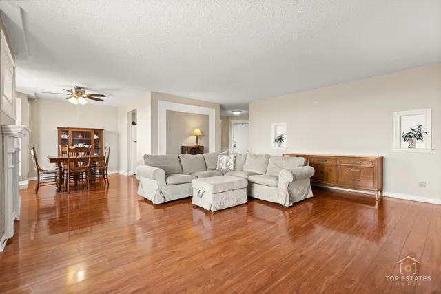 a living room with furniture and a wooden floor