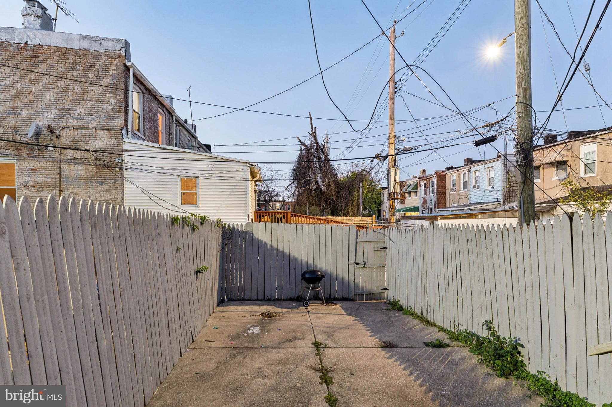 1828 Walbrook Avenue Baltimore, MD 21217 - Photo 14 of 15 a view of a house with a wooden fence