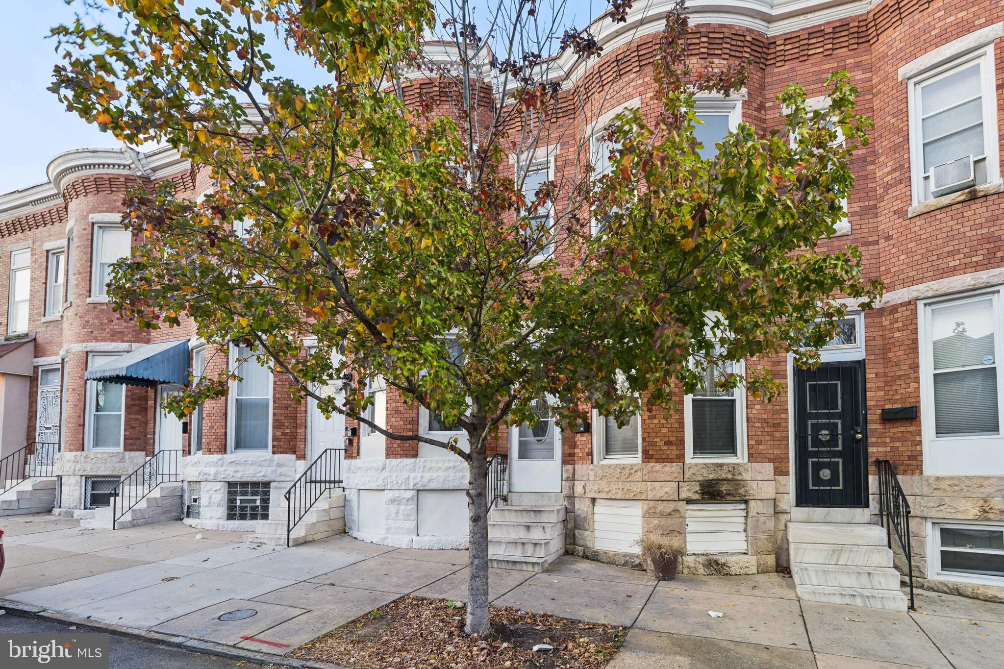 1828 Walbrook Avenue Baltimore, MD 21217 - Photo 3 of 15 a front view of a house with a tree
